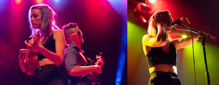 Two photographs side by side. On the left are a white woman and a white man standing back-to-back. Both are playing guitars. Behind them are stage lights casting an orange and blue glow. On the right, a white woman standing in front of a microphone stand. She has one hand raised to her head and another hand holding a microphone. Behind her is a stage light casting and orange and green glow.