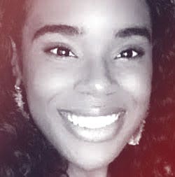 A photograhic profile portrait of a young Black woman facing the camera.