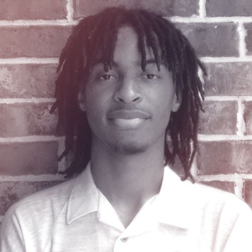 A photographic profile portrait of a young man facing the camera.
