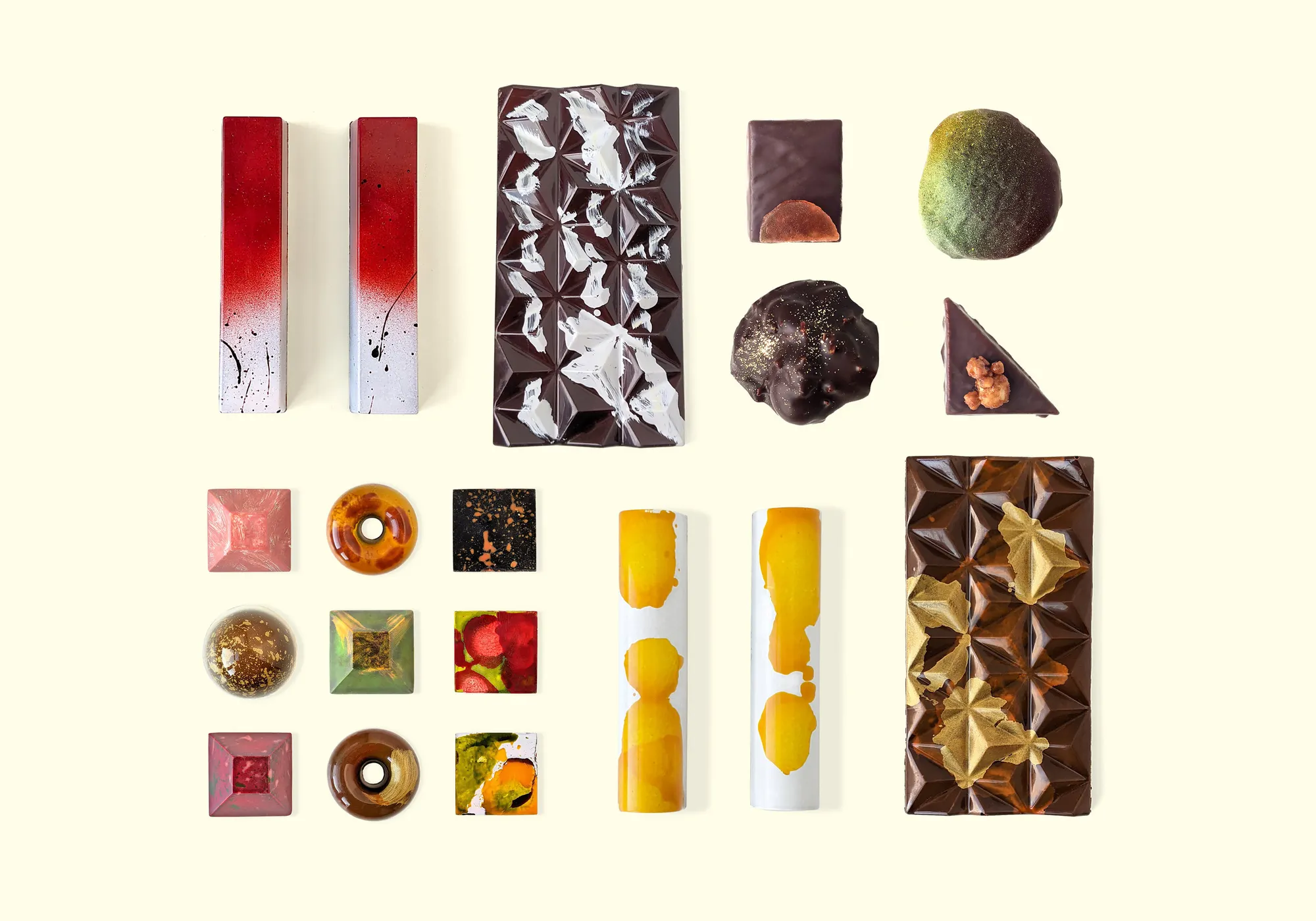 A photograph of two rows of artfully arranged chocolates and chocolate bars.