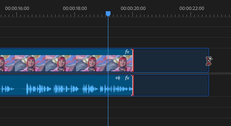 A screenshot of an expanded view of the Adobe Premiere Pro video editing timeline. At the top are 00:00:16:00, 00:00:18:00, 00:00:20:00, and 00:00:2:00 timestamps. The editing timeline contains five frames of video and sound that stop at the 00:00:20:00-minute mark. The remainder of the timeline is blank space. The frames are of a white woman with pink hair wearing a pink jacket and multiple necklaces against a wavy-lined background of pink, gray, blue, and gold.